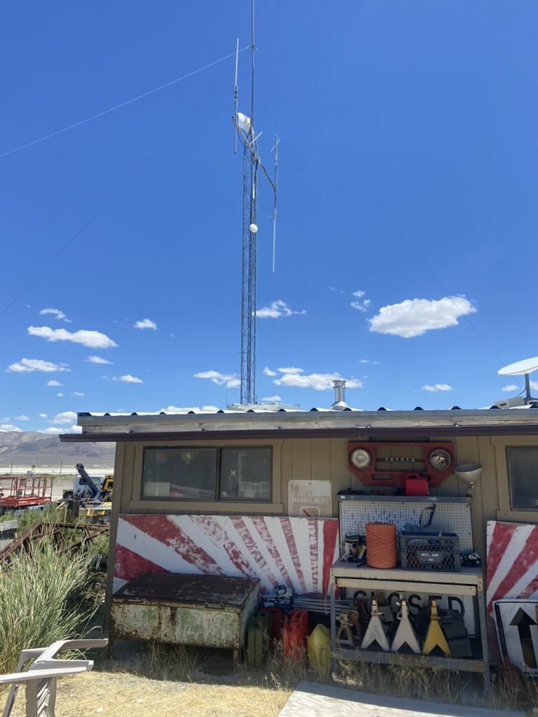 Ranger Outpost Gerlach compound with lattice tower, Starlink dish, and Toyota Land Cruiser grille on the shelter