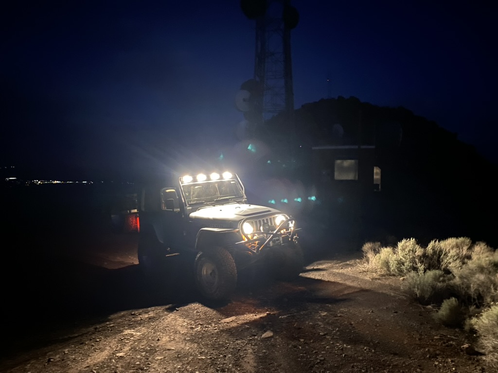 Jeep Rubicon with light bar at the High Sierra compound on Toulon Peak after dark