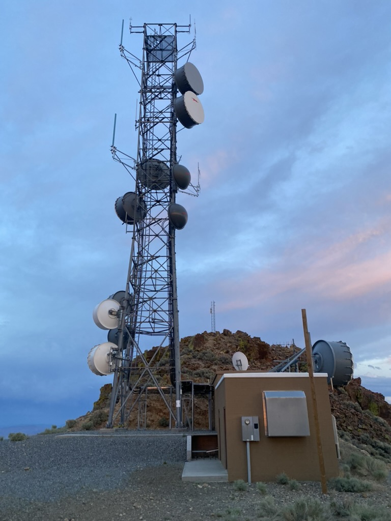 High Sierra Communications tower compound on Toulon Peak at dusk
