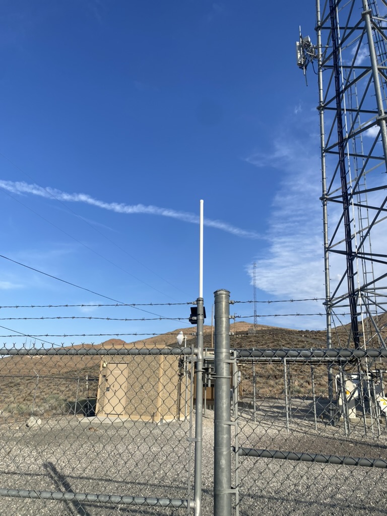 Fence node with 8 dBi fiberglass antenna zip-tied to the Patrick Tower perimeter