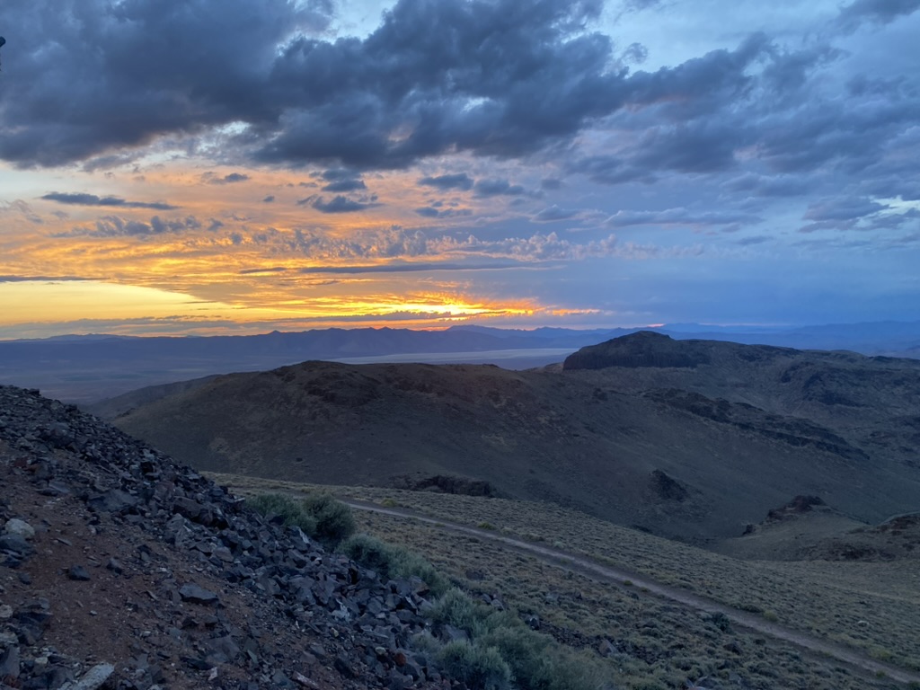 Sunset over the desert hills and dirt road below Toulon Peak