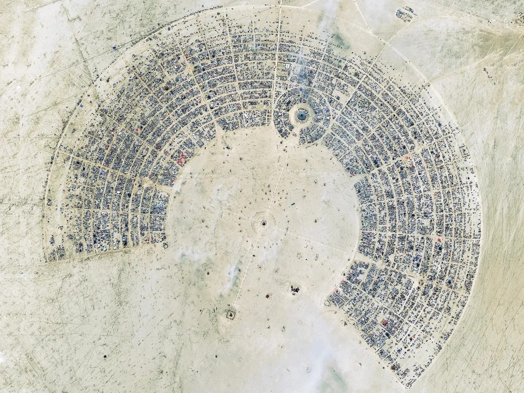 Aerial view of Black Rock City on the playa, the semi-circular street grid visible from above