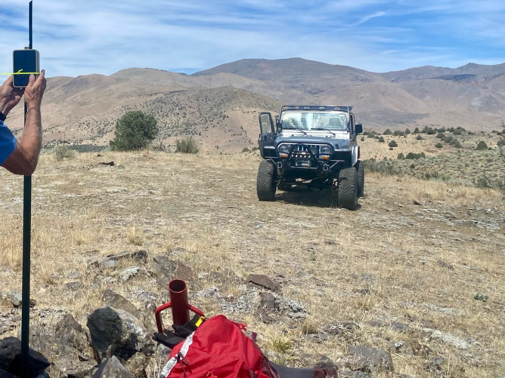 Jeep on the hillside during the Topaz stake, zip-tie mount on a T-post