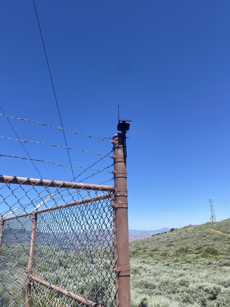 Close-up of the solar node zip-tied to the perimeter fence
