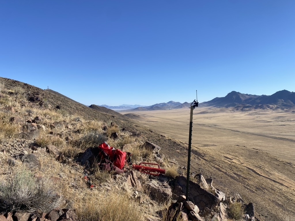 T-post mesh mount on a rocky Poito slope overlooking the desert playa below