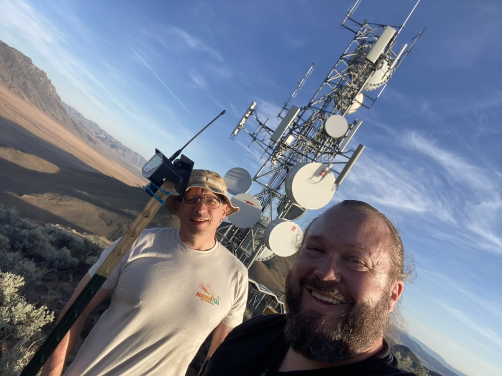 Original Poito node on a wooden mast at Dave Metts's tower compound, microwave dishes on the lattice tower behind
