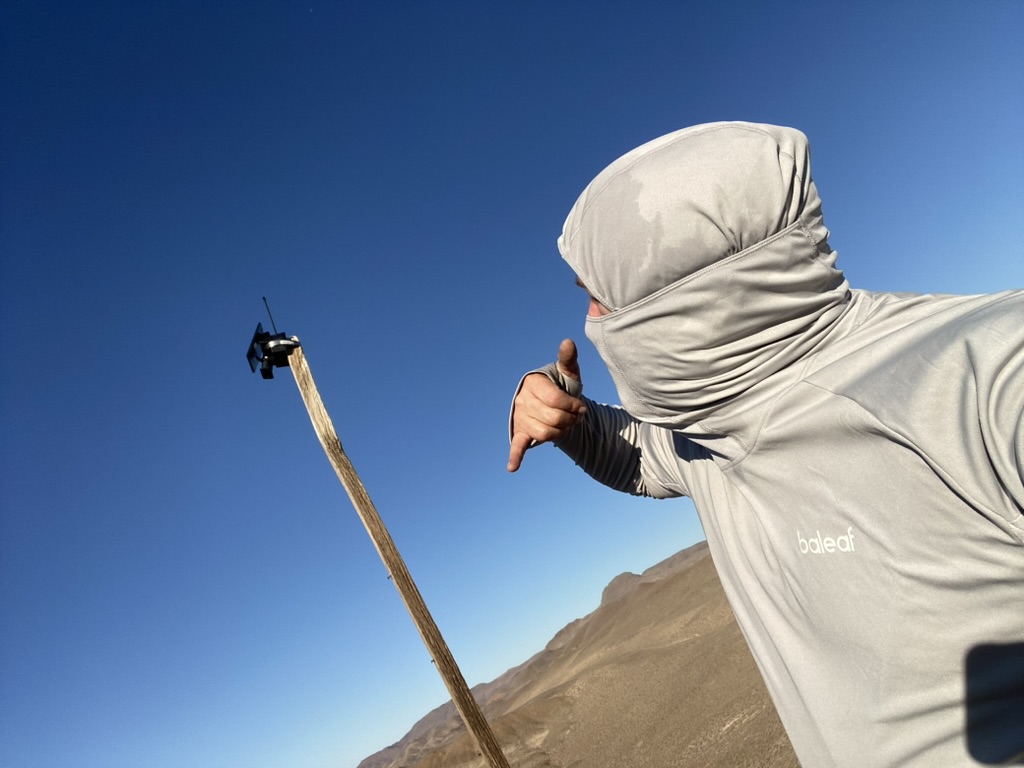 Mesh node secured to a wooden mast on Russell Peak, desert basin in the background